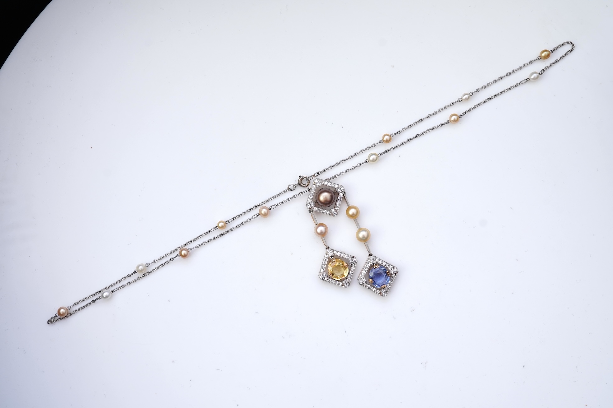 An Art Deco sapphire, natural pearl and diamond necklace, circa 1920